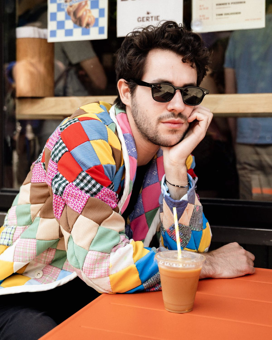 Patchwork panel jacket at an outdoor cafe table