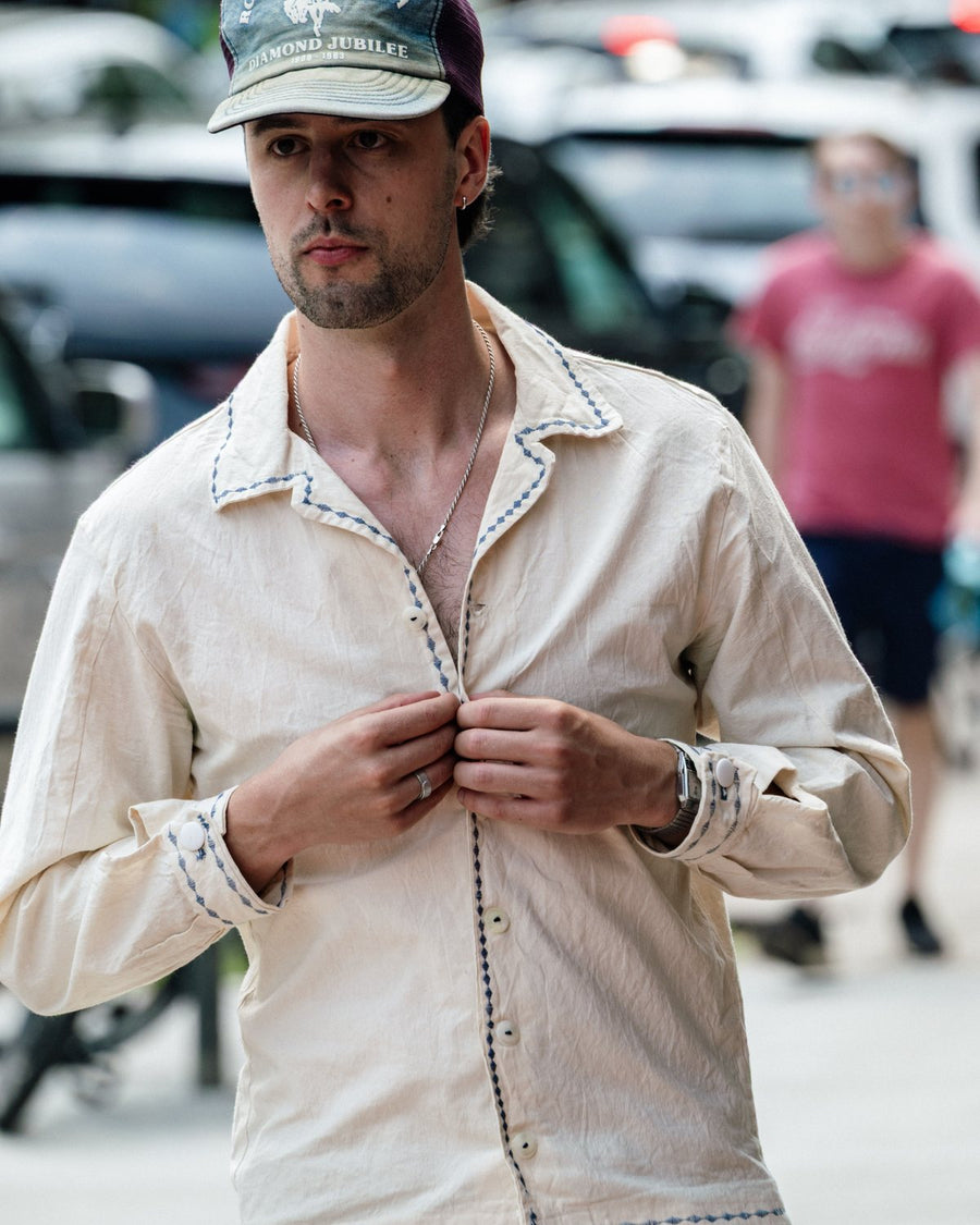 Cream western shirt with contrast stitching, buttoning the placket